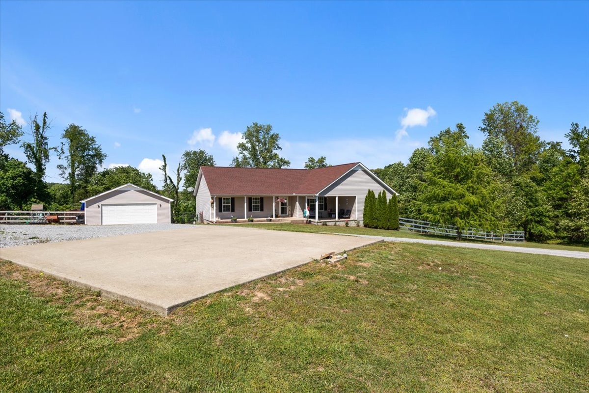 109 Bessie Clark Road Erin, TN 37061 - Photo 5 of 43 a front view of a house with a yard and trees