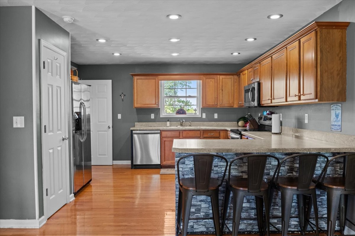 109 Bessie Clark Road Erin, TN 37061 - Photo 10 of 43 a kitchen with stainless steel appliances granite countertop a table chairs sink refrigerator and cabinets