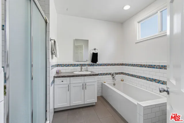 a bathroom with a bathtub and a sink