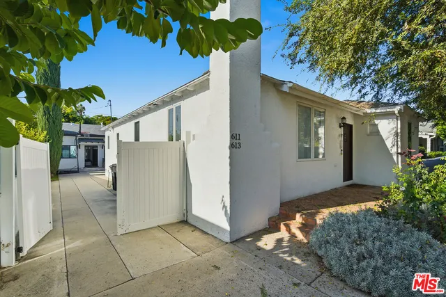 a view of backyard with outdoor seating and plants