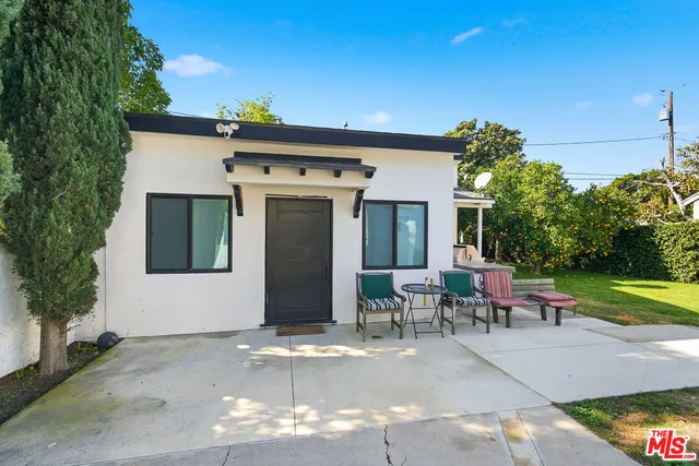 a view of a patio with table and chairs and potted plants