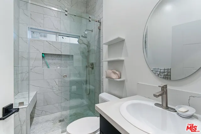 a bathroom with a sink toilet and shower
