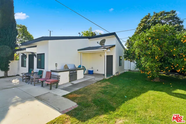 a view of a patio with table and chairs and potted plants