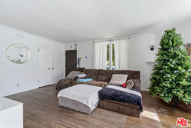 a bedroom with furniture and a potted plant