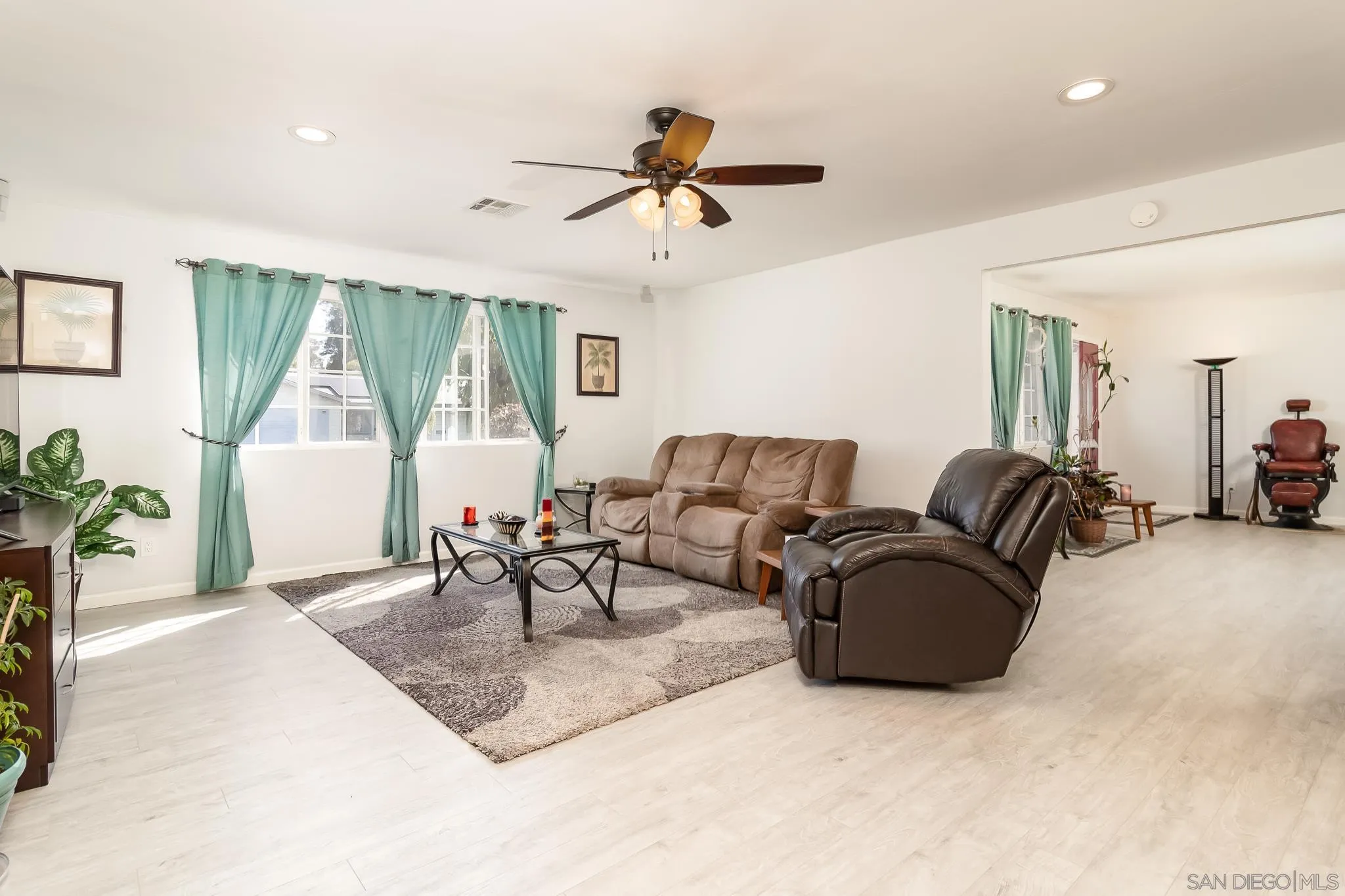 9780 Highdale Road Santee, CA 92071 - Photo 3 of 20 a living room with furniture a table and a chandelier