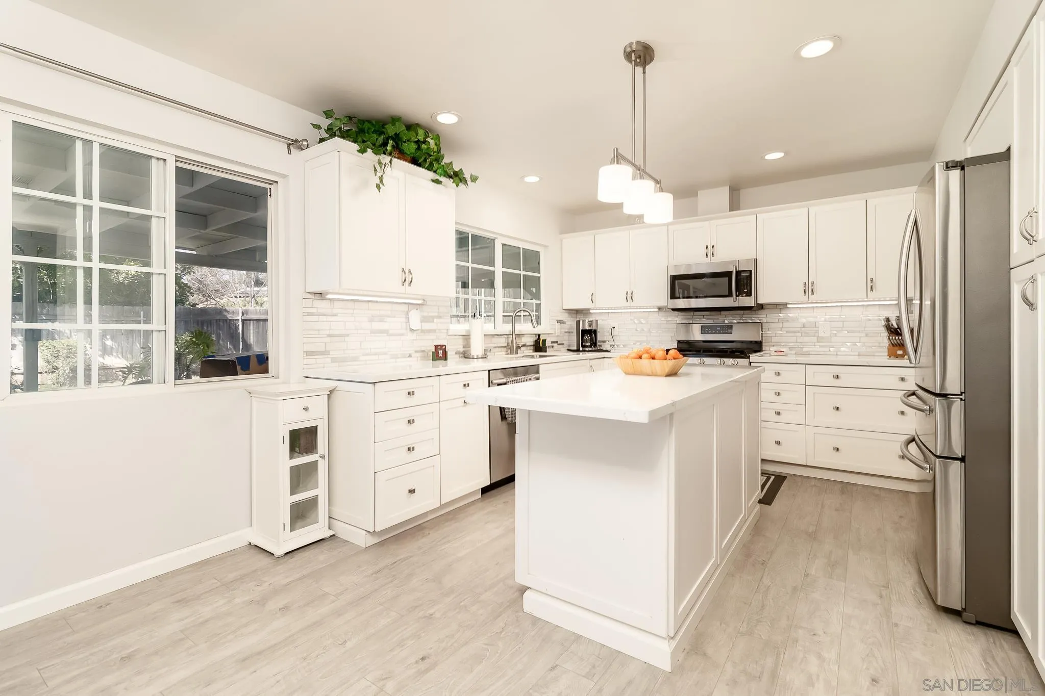 9780 Highdale Road Santee, CA 92071 - Photo 6 of 20 a kitchen with white cabinets and white appliances