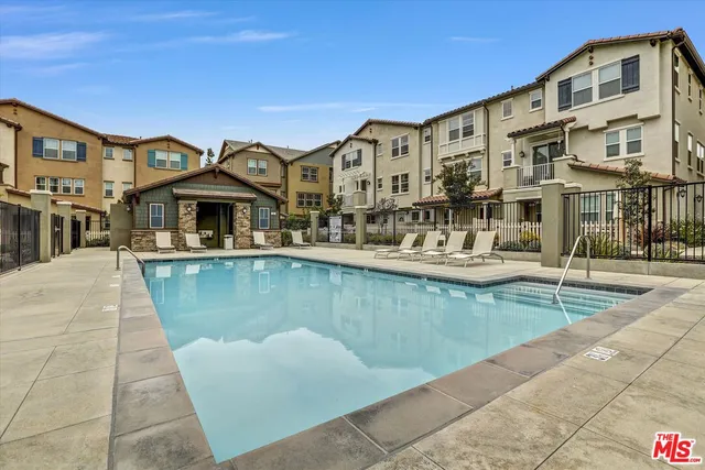 an aerial view of residential houses with outdoor space and seating