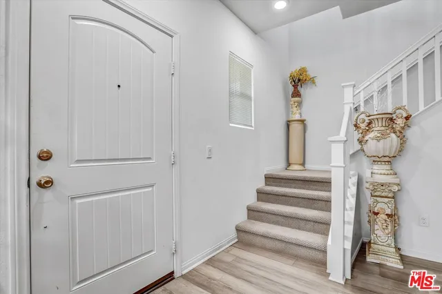 a view of entryway with stairs and wooden floor
