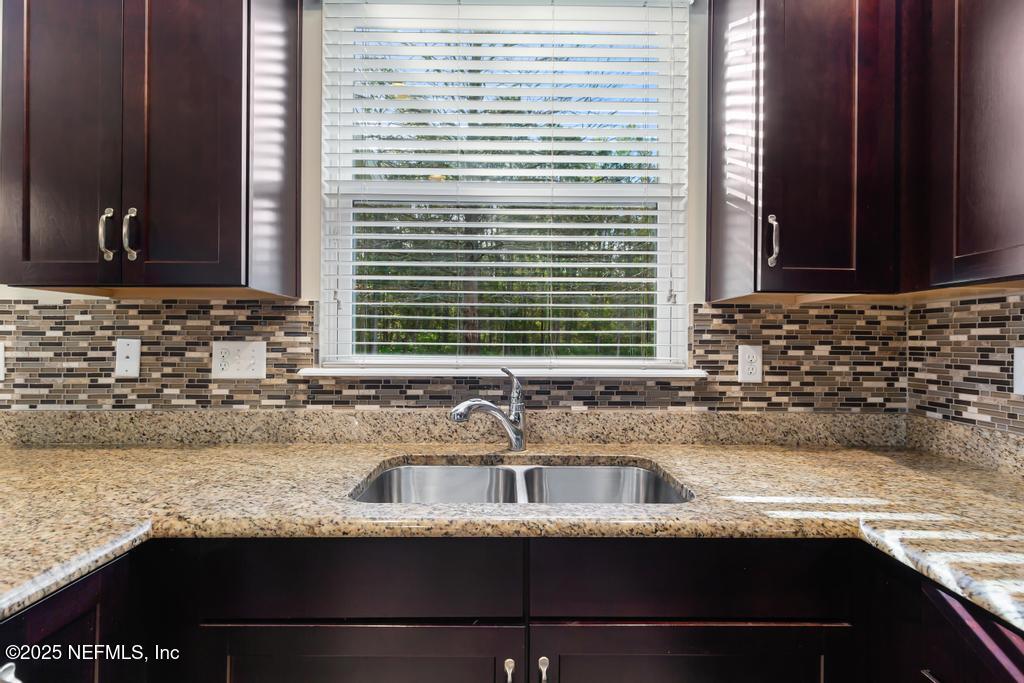 102 San Briso Way St. Augustine, FL 32092 - Photo 23 of 62 a kitchen with granite countertop a sink and a window