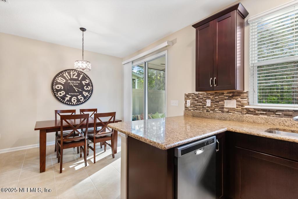 102 San Briso Way St. Augustine, FL 32092 - Photo 24 of 62 a view of a kitchen area with a table and chairs