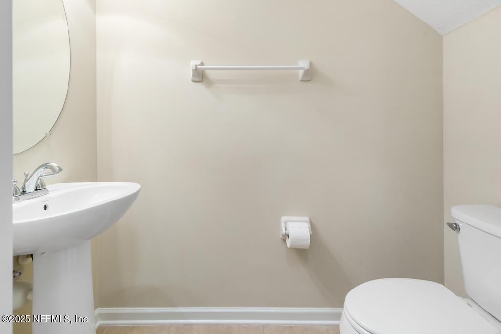 102 San Briso Way St. Augustine, FL 32092 - Photo 27 of 62 a bathroom with a sink a toilet and mirror