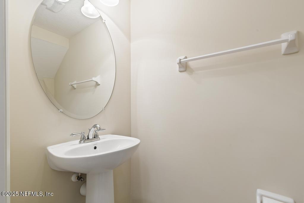 102 San Briso Way St. Augustine, FL 32092 - Photo 28 of 62 a bathroom with a sink a mirror and a shower