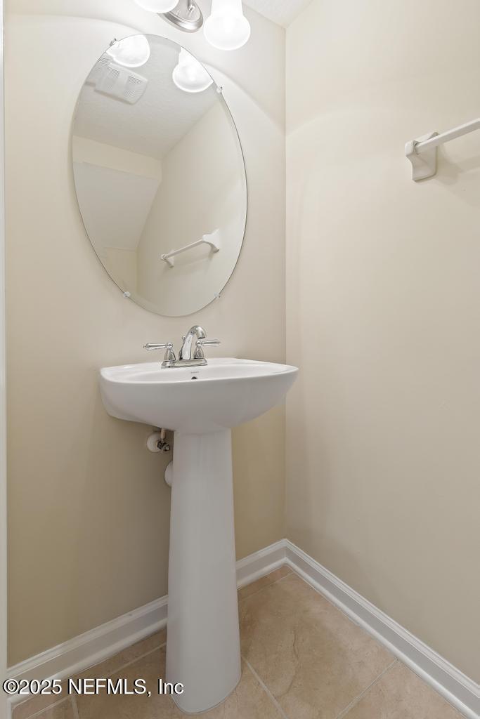 102 San Briso Way St. Augustine, FL 32092 - Photo 29 of 62 a bathroom with a sink a mirror and vanity