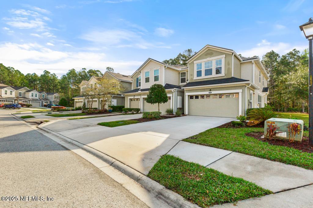 102 San Briso Way St. Augustine, FL 32092 - Photo 3 of 62 a front view of a house with a garden