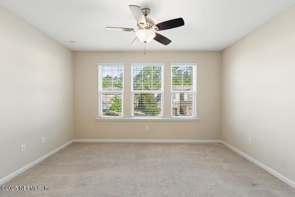 102 San Briso Way St. Augustine, FL 32092 - Photo 37 of 62 an empty room with a window and a ceiling fan