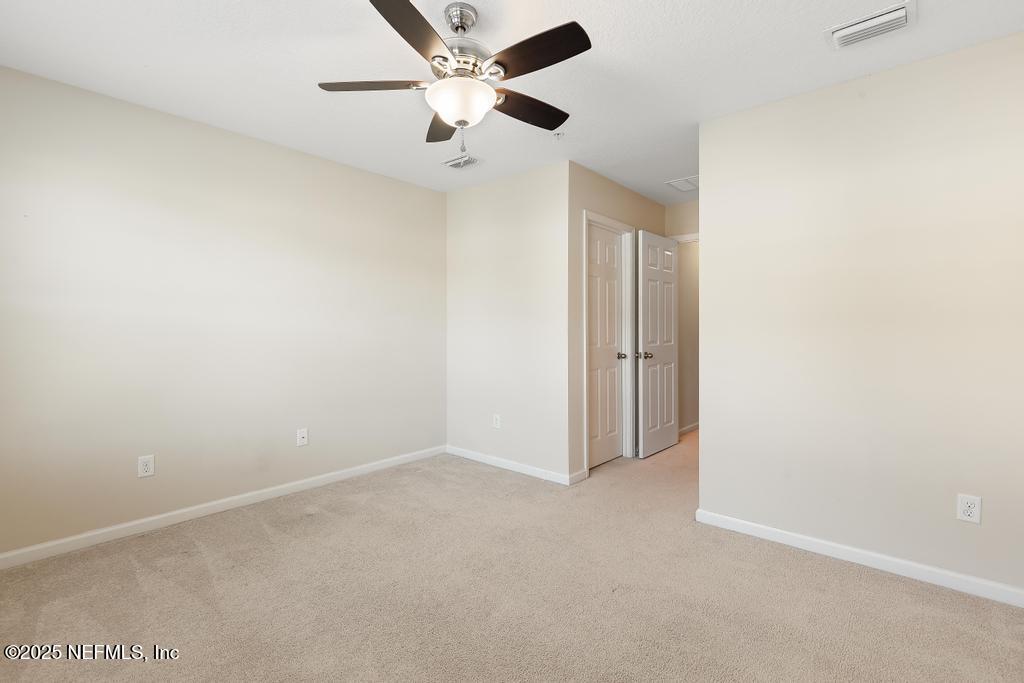 102 San Briso Way St. Augustine, FL 32092 - Photo 38 of 62 an empty room with a fan & a ceiling fan
