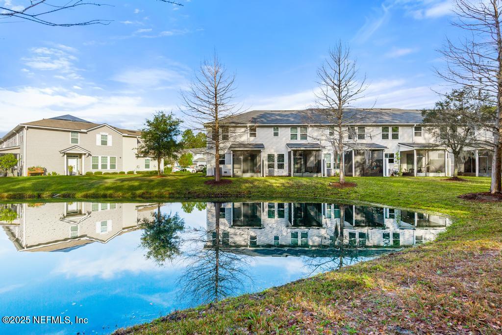 102 San Briso Way St. Augustine, FL 32092 - Photo 58 of 62 a front view of a house with a garden and lake view