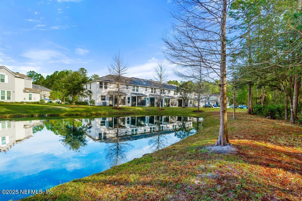 102 San Briso Way St. Augustine, FL 32092 - Photo 59 of 62 a view of a lake with a building in the background