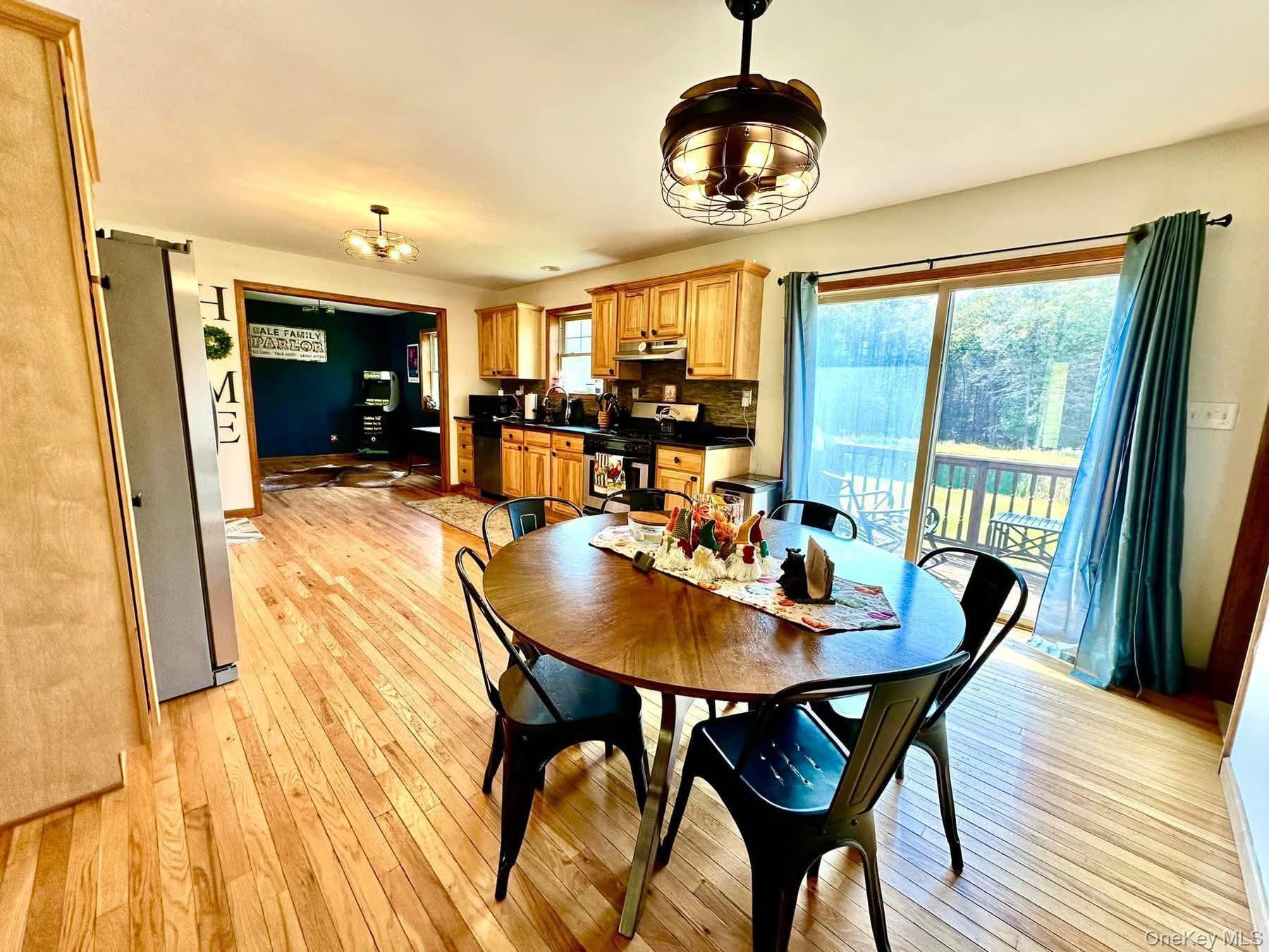 595 Hurd And Parks Road Swan Lake, NY 12783 - Photo 17 of 43 Dining room with a chandelier, plenty of natural light, and light wood-style floors