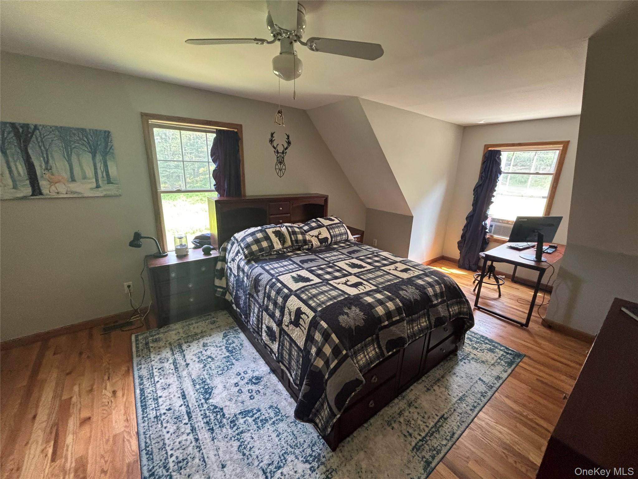595 Hurd And Parks Road Swan Lake, NY 12783 - Photo 35 of 43 Bedroom with wood finished floors and a ceiling fan