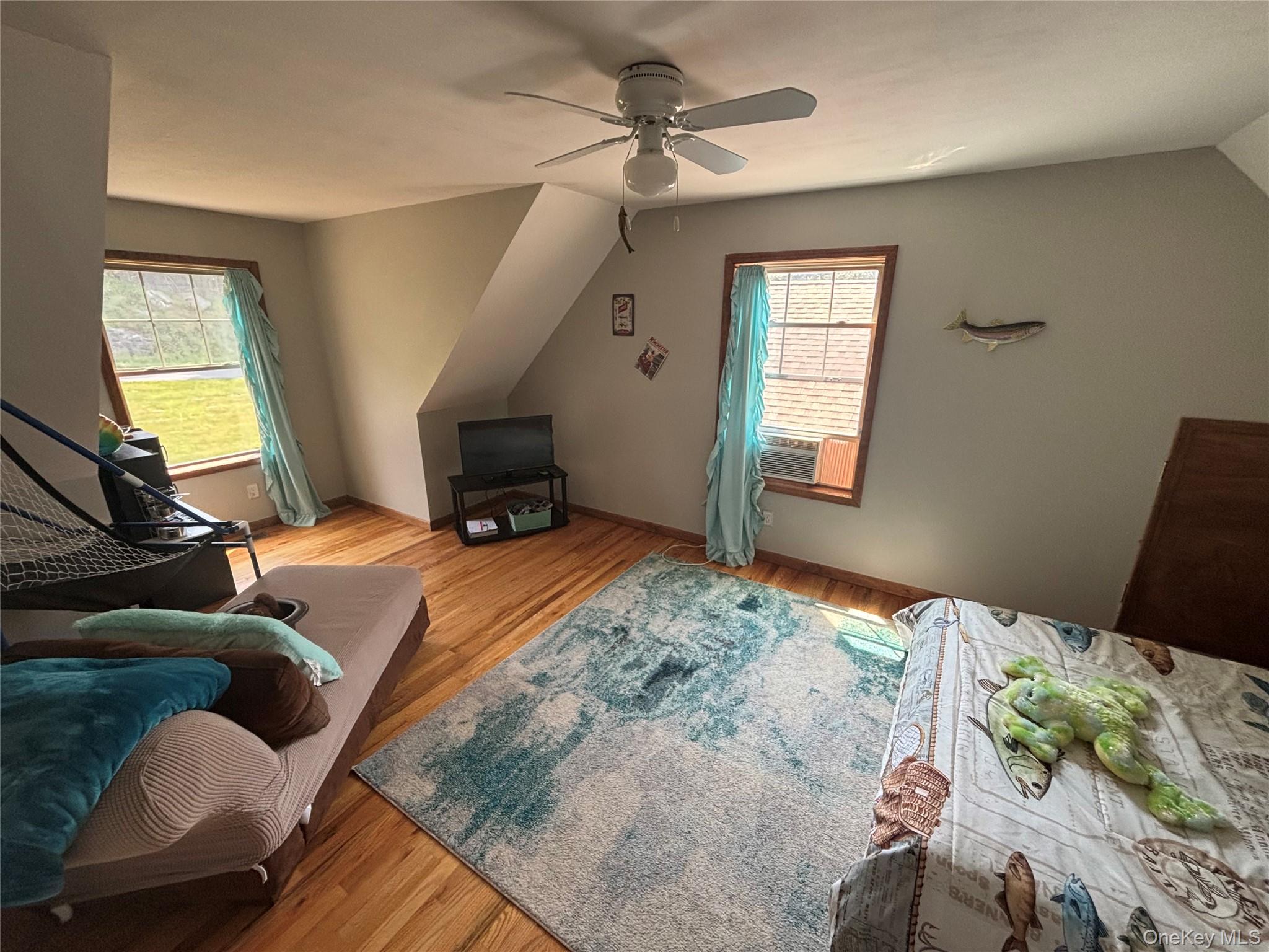 595 Hurd And Parks Road Swan Lake, NY 12783 - Photo 38 of 43 Bedroom featuring light wood-type flooring, vaulted ceiling, and ceiling fan