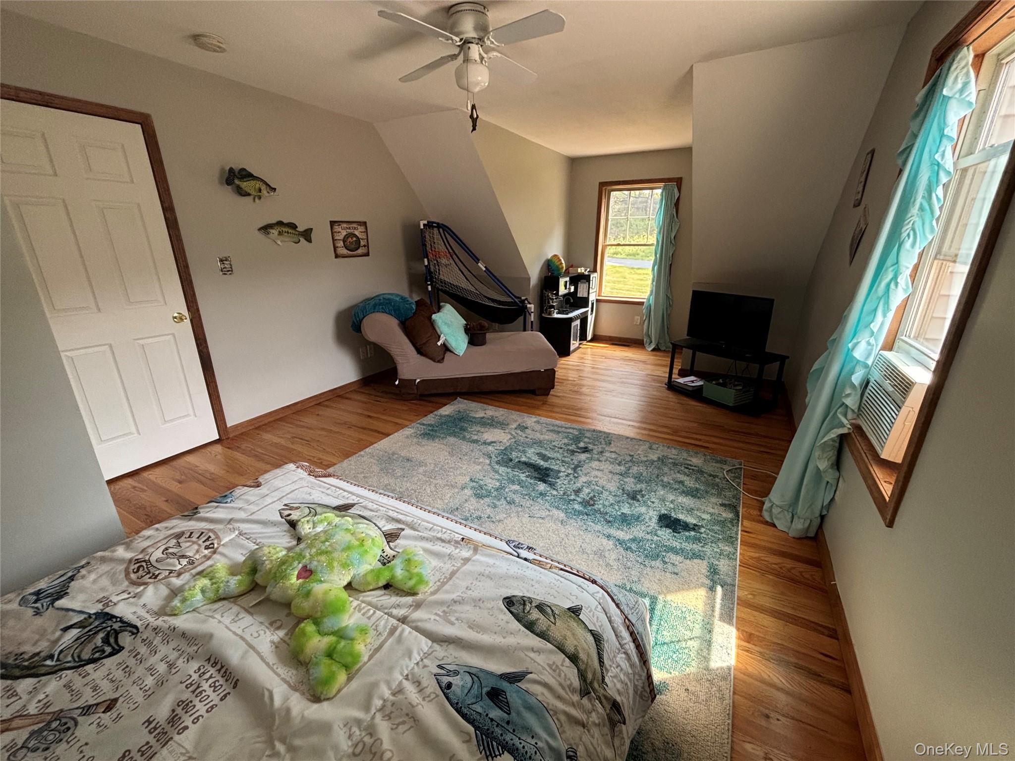 595 Hurd And Parks Road Swan Lake, NY 12783 - Photo 39 of 43 Living area with wood finished floors, ceiling fan, and cooling unit