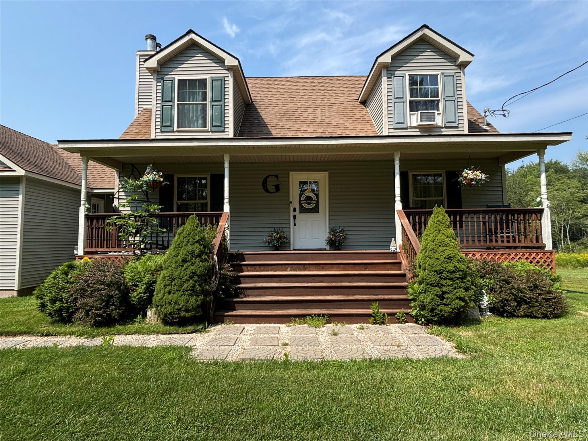 595 Hurd And Parks Road Swan Lake, NY 12783 - Photo 4 of 43 View of front of home with a porch, a front yard, roof with shingles, and a chimney
