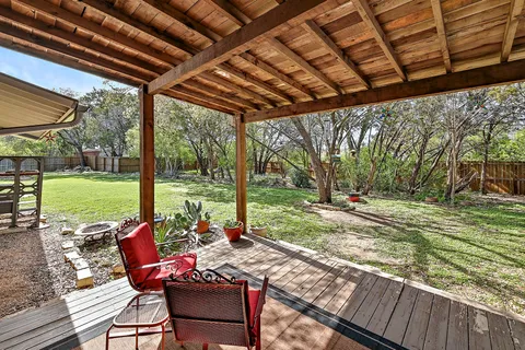 a view of a patio with a table chairs and a backyard