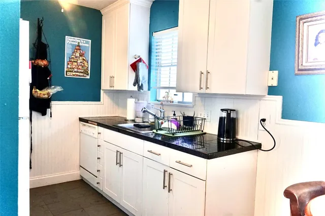 a kitchen with sink cabinets and window