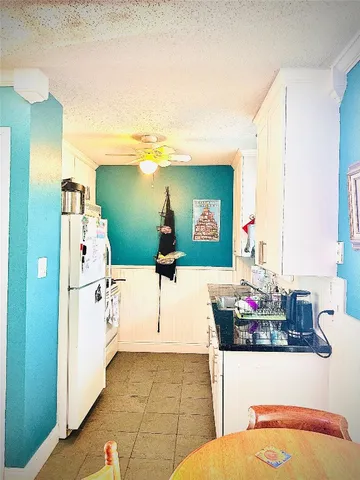 a white refrigerator freezer sitting inside of a kitchen