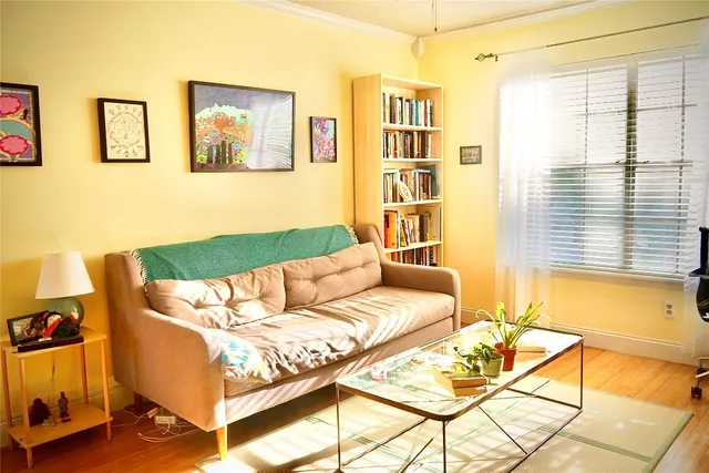 a bedroom with a bed and a potted plant