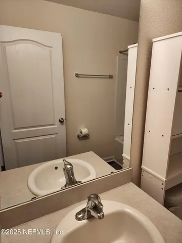 a bathroom with a sink and a mirror