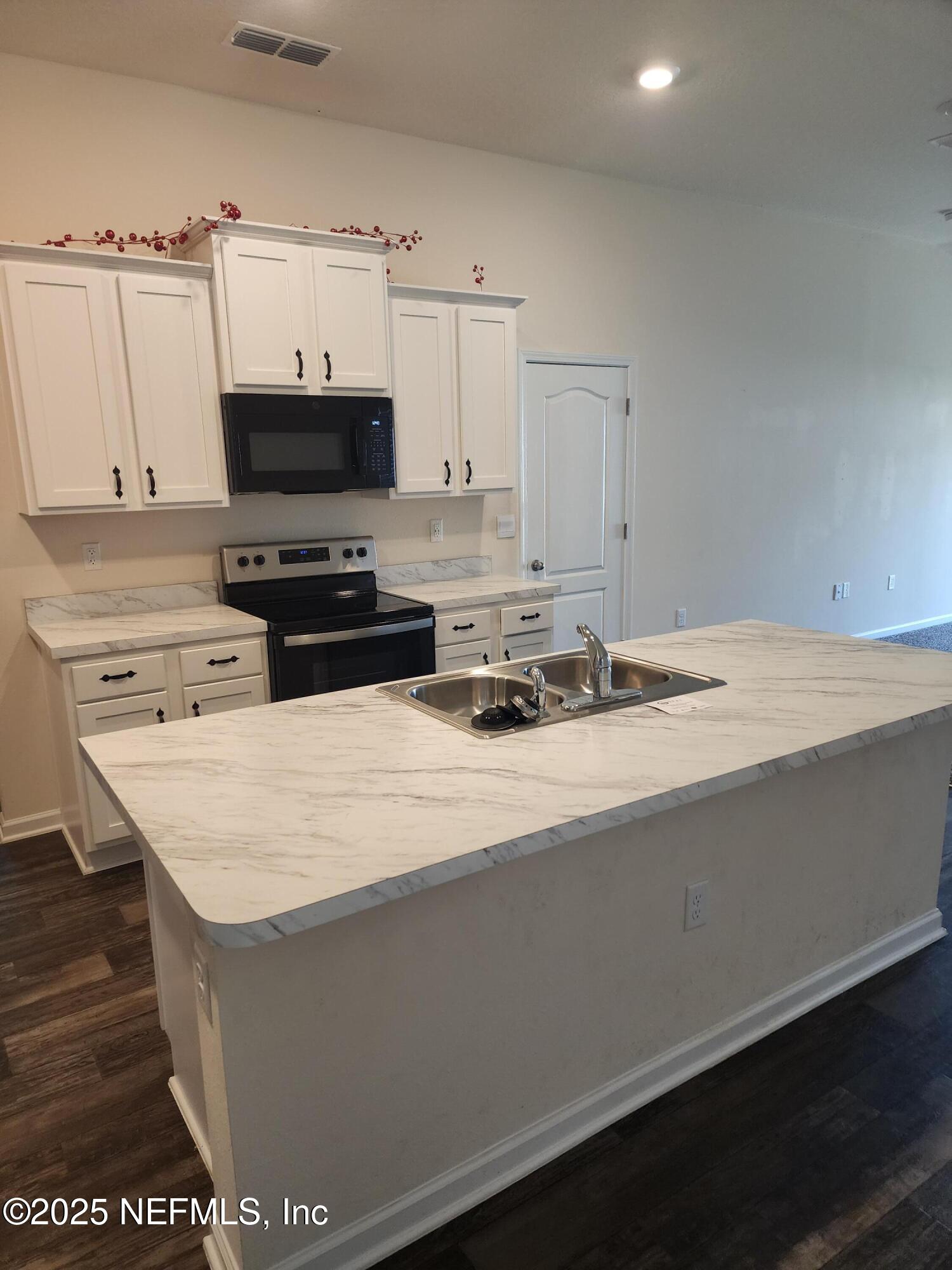 2295 Falling Star Ln Green Cove Springs Green Cove Springs, FL 32043 - Photo 5 of 24 a kitchen with stainless steel appliances a sink a stove and a refrigerator