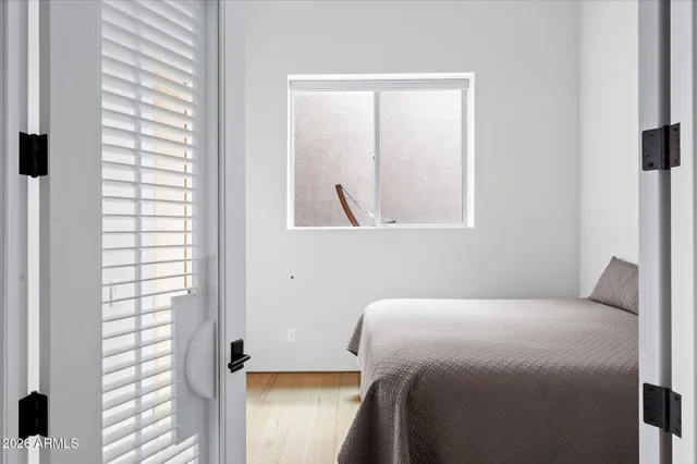 a bedroom with a bed and a window