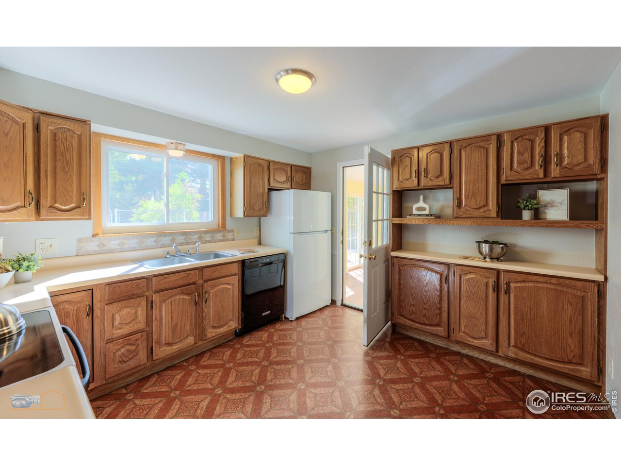 1050 Berea Drive Boulder, CO 80305 - Photo 17 of 40 a kitchen with stainless steel appliances granite countertop a refrigerator sink and cabinets