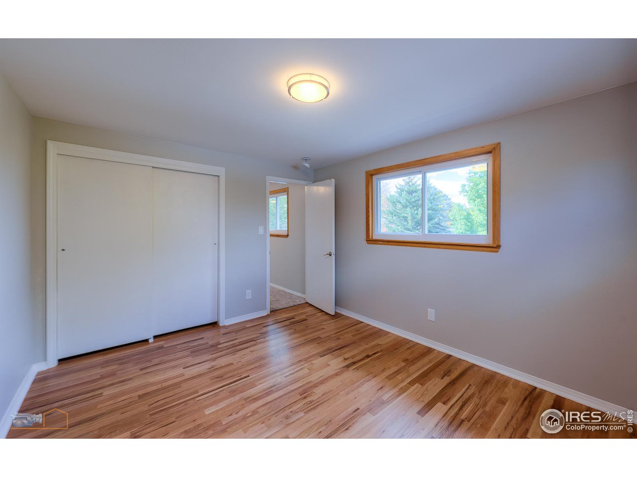 1050 Berea Drive Boulder, CO 80305 - Photo 23 of 40 a view of an empty room with wooden floor and windows
