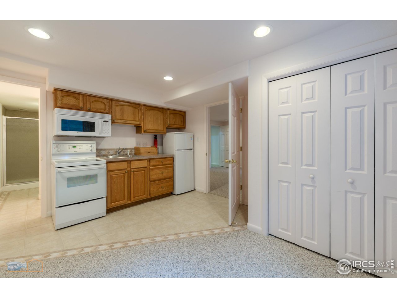 1050 Berea Drive Boulder, CO 80305 - Photo 29 of 40 a kitchen with white cabinets and white appliances
