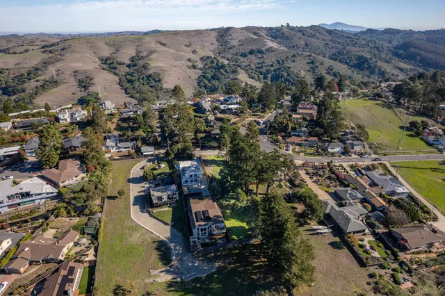 an aerial view of a swimming pool patio and swimming pool