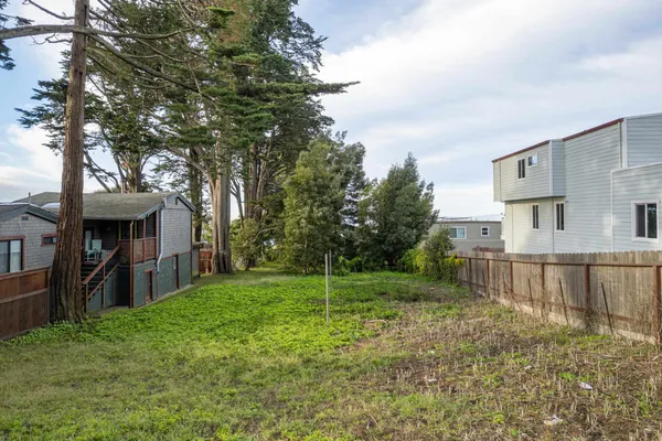 a view of a house with a yard and deck