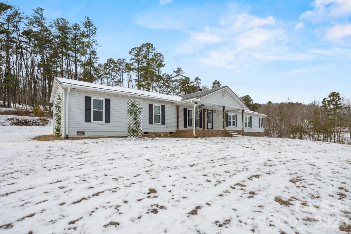 4855 Talley Road Walkertown, NC 27051 - Photo 5 of 45 a wooden house with a large tree in front of a house