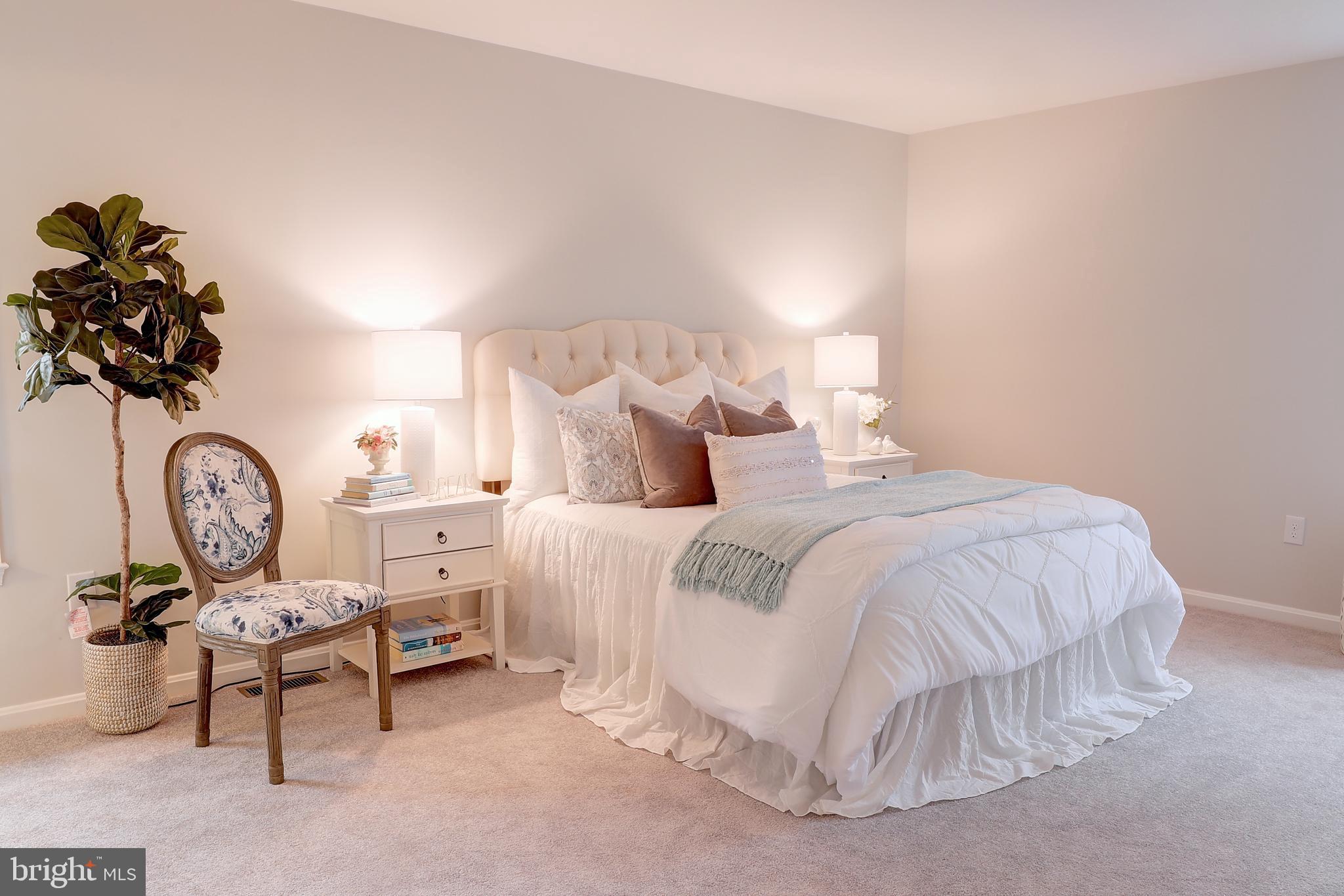695 Hillmeade Road Edgewater, MD 21037 - Photo 18 of 28 a bedroom with a bed and a chandelier