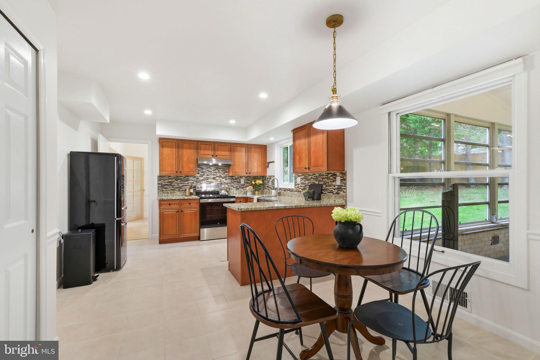 10900 Gainsborough Road Potomac, MD 20854 - Photo 14 of 44 a dining room with furniture a window and kitchen view