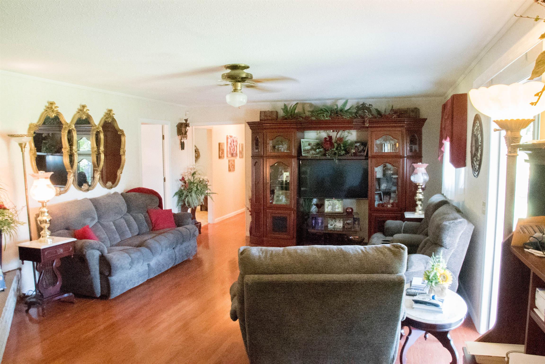 8531 Red Boiling Springs Road Lafayette, TN 37083 - Photo 8 of 29 a living room with furniture and a flat screen tv