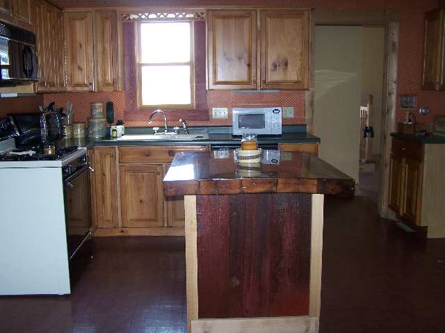 2287 West Hanover Road Hanover, IL 61041 - Photo 2 of 9 a kitchen with stainless steel appliances granite countertop a refrigerator a sink dishwasher a stove and white countertops with wooden floor