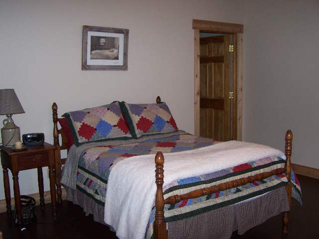 2287 West Hanover Road Hanover, IL 61041 - Photo 5 of 9 a bedroom with a bed and a dresser next to it