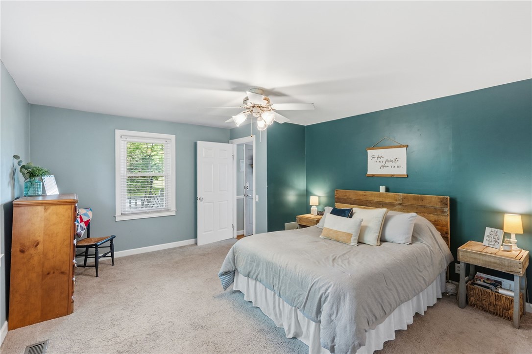 108 Tarrant Street Central, SC 29630 - Photo 20 of 42 A tranquil bedroom features a spacious layout with soft carpeting and a bright window overlooking verdant foliage.
