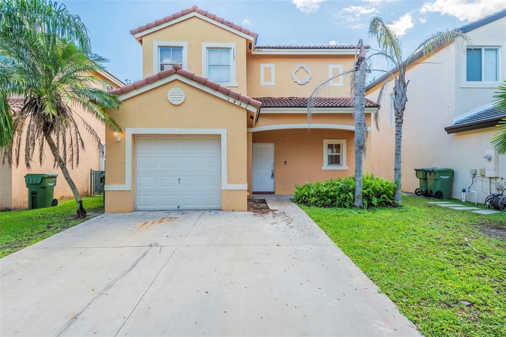 1441 Southeast 20th Road Homestead, FL 33035 - Photo 1 of 1 a front view of a house with a yard and garage