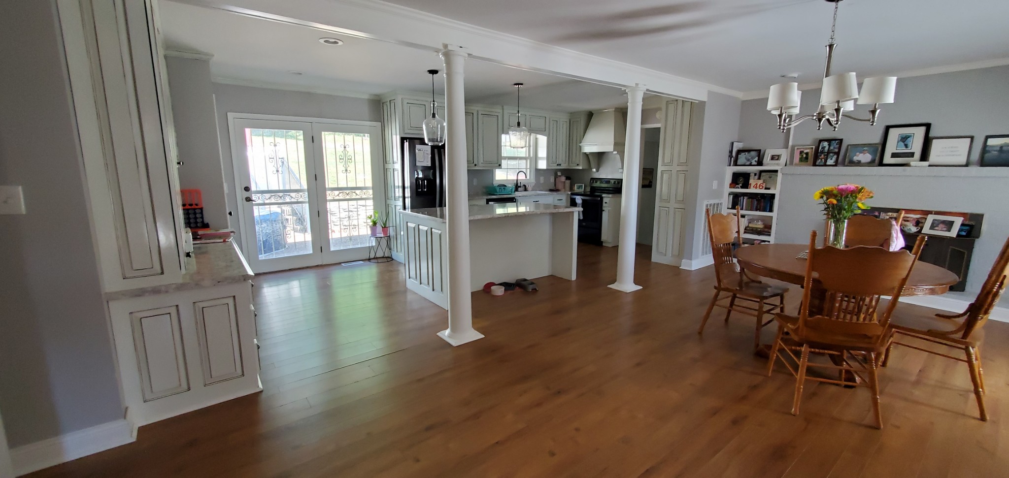 a view of a dining room with furniture and wooden floor
