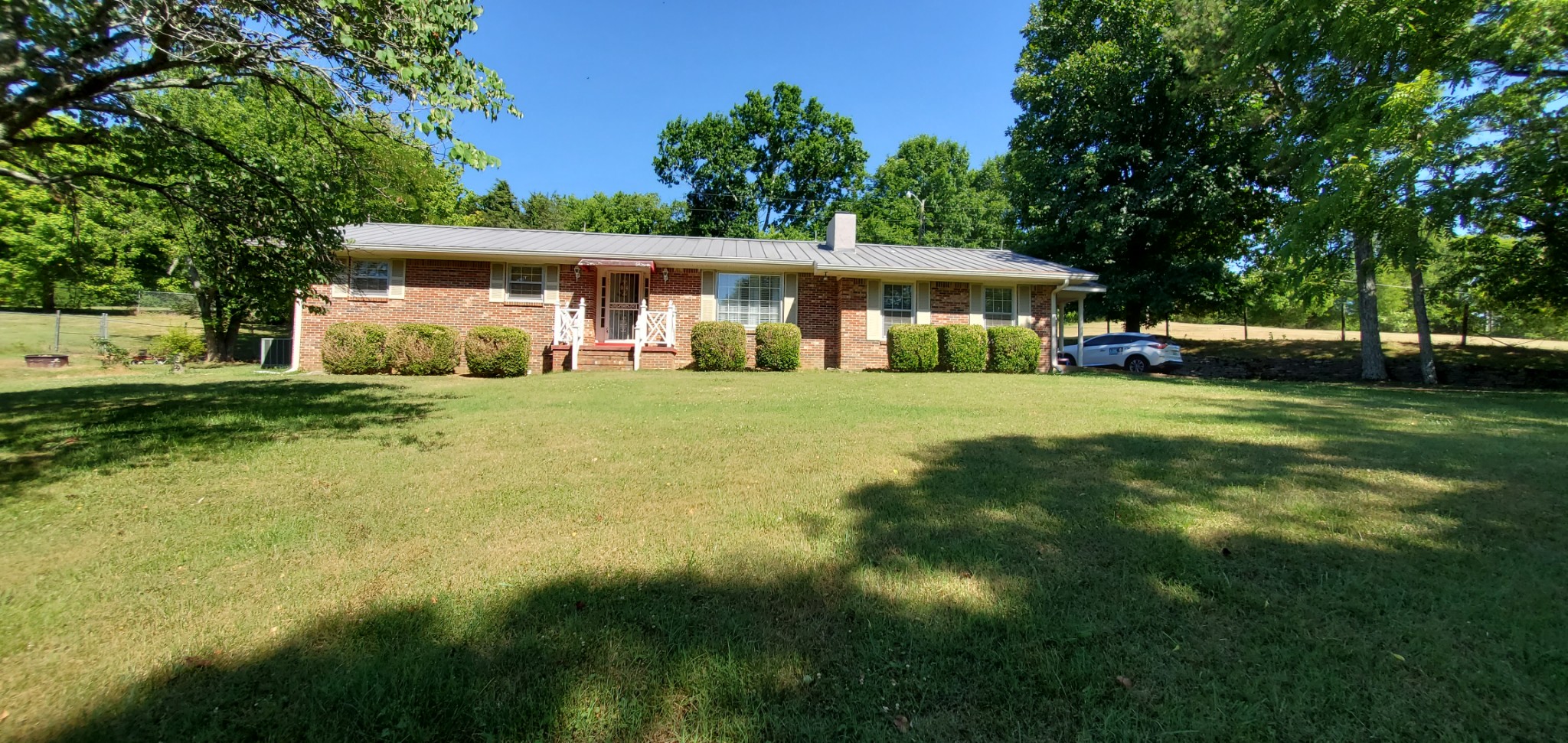 1915 Crescentview Road Pulaski, TN 38478 - Photo 8 of 28 a view of a house with a big yard and large trees