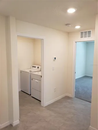 a utility room with cabinets washer and dryer
